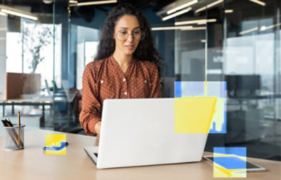 A person sitting at a desk using a laptop.