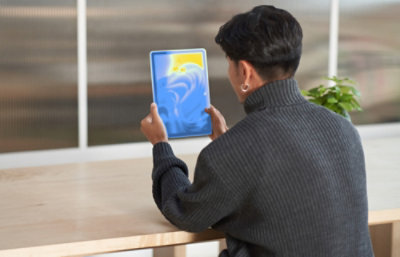 A person holding a tablet.