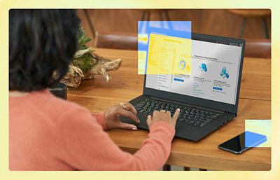 A woman typing on a laptop.