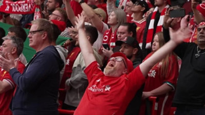 A group of people on a football field wearing red T-shirt