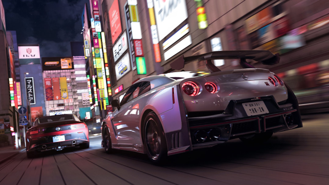 Two cars racing through a city street.