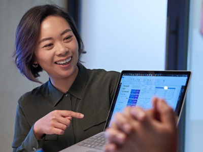 A smiling woman looking at laptop