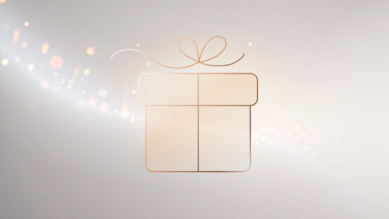 A minimalist line-art gift box with a ribbon sits against a soft champagne background with glowing, sparkling light effects.