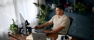 A Person using a desktop computer at a desk