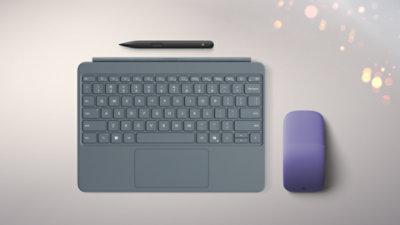Top-down view of a Surface Pro Keyboard in the color Ocean with an Arc Mouse in the color Violet and a Slim Pen. 