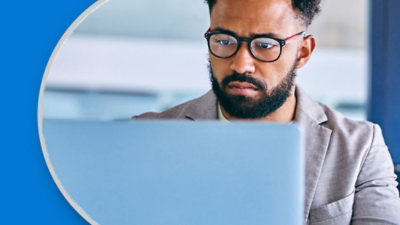 Person working on a laptop in a bright office environment