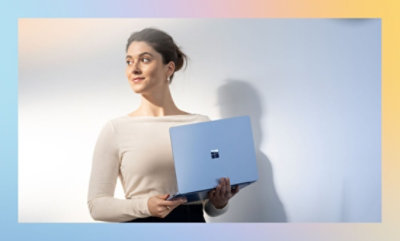 A woman holding a laptop.