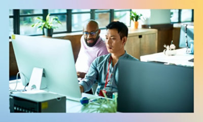 A group of men working on a computer.