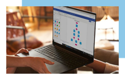 Hands holding a laptop displaying a flowchart on its screen.