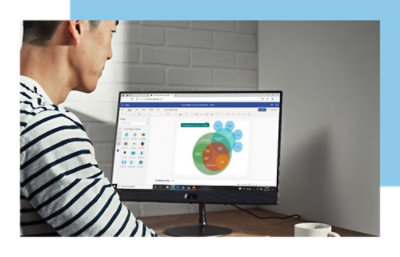 Person working on a computer with a colorful graph displayed on the screen.