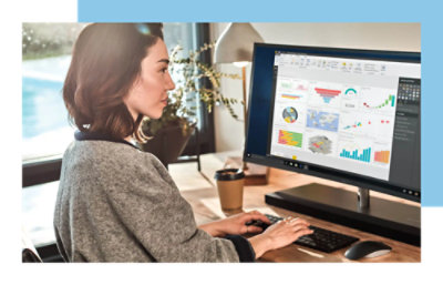 Person working on a computer with data analysis graphs on the screen.