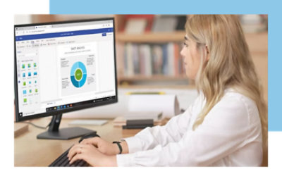 A person working on a computer with a pie chart and data analysis on the screen.