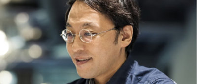 A person wearing glasses looking at the screen