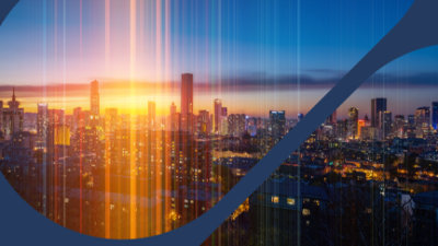 A city skyline with a sunset behind it