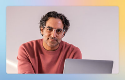 A man wearing glasses and a pink shirt
