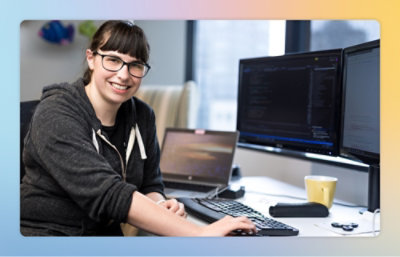 A person sitting at a desk with a computer.