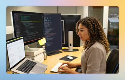 A woman sitting at a desk using a computer