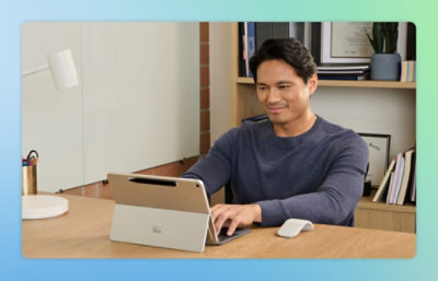 Eine Person, die mit einem Laptop an einem Tisch sitzt