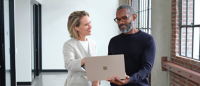 Ein Mann und eine Frau, die einen Laptop halten