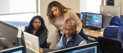 A group of people working on computers.