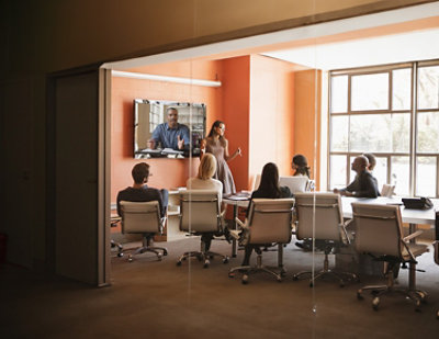 A woman giving a presentation to a group of people.