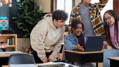 A group of people looking at a computer