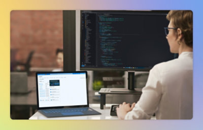A man sitting at a desk with a laptop.