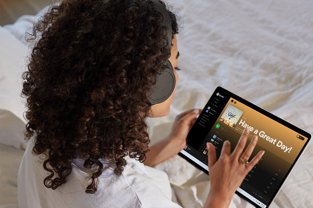 Surface Pro X being used as a tablet to listen to a music player.