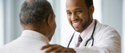 A doctor placing his hand on a patient's shoulder