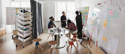 A group of people looking at a whiteboard