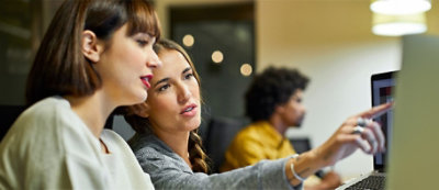 A group of women looking at a computer screen
