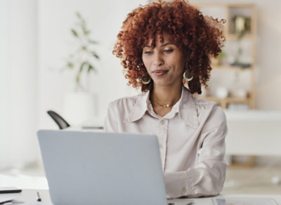 Person working on a laptop at a desk.