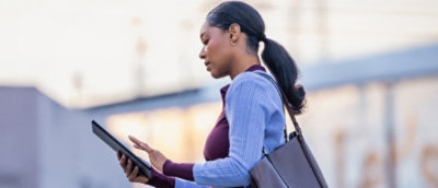 Person using a tablet outdoors.