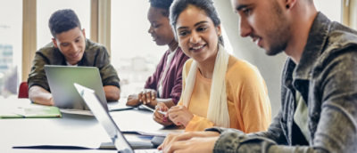 Group discussion with laptops in a meeting room