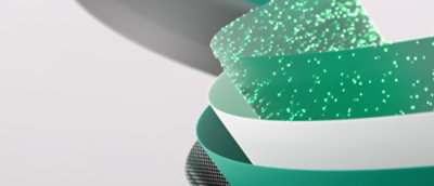 A close-up of a stack of paper on a green and white speckled surface.