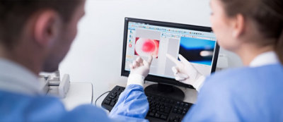 A person pointing at a computer screen