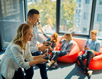  A blurry image of a woman sitting on a red bean bag chair.