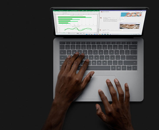 A person uses Surface Laptop Studio in laptop mode.
