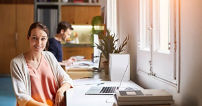 A person sitting at a desk with a computer