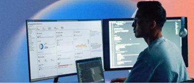 A person sitting at a desk with a laptop computer.