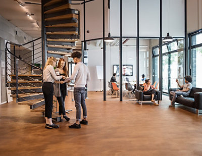 Open office space with people socializing and working. 