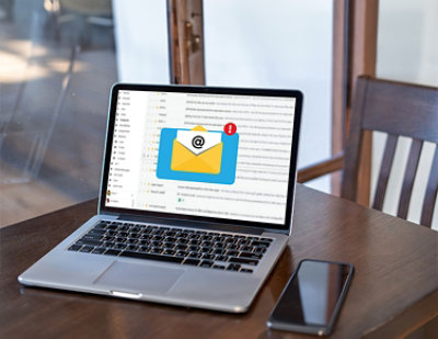 A laptop with an email on the screen.