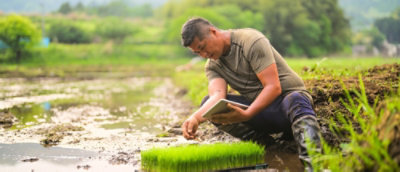 a man kneeling in the mud