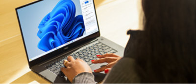 A woman sitting at a desk with Laptop.