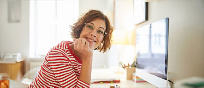 A person with her hand on her chin smiling