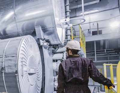 A man wearing a white helmet and black jumpsuit.