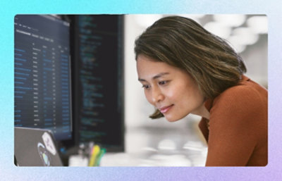 A person sitting in front of a computer screen.