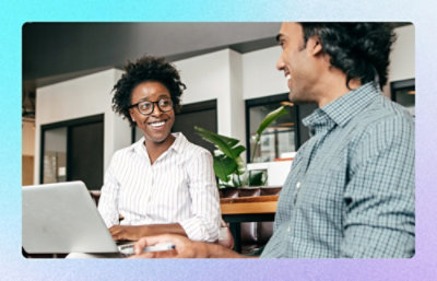 A man and woman looking at a laptop.
