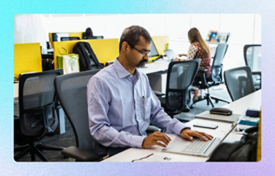 A woman is working on a laptop.