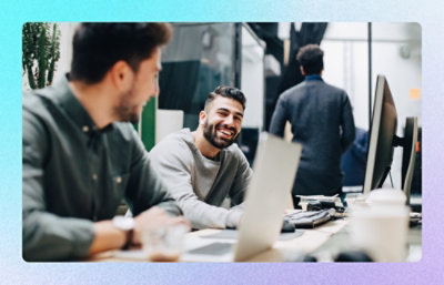A group of men sitting at a table with a laptop.